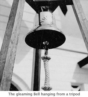 The gleaming 
bell hanging from a tripod